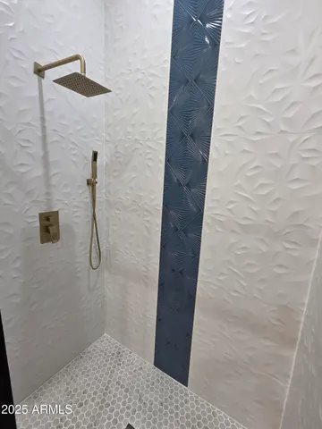 a bathroom with a glass door shower
