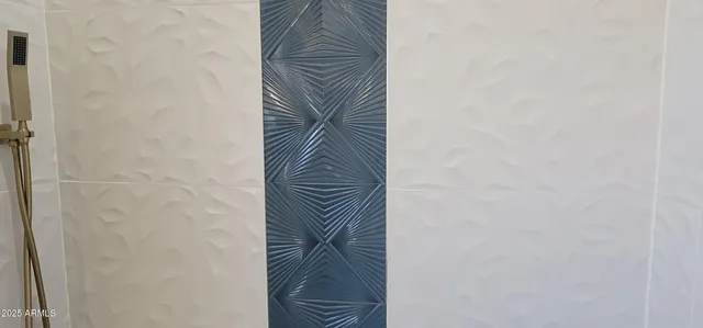 a white toilet sitting next to a white wall