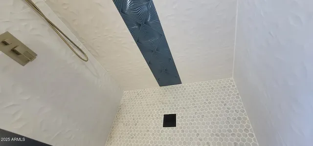 a white toilet sitting next to a shower