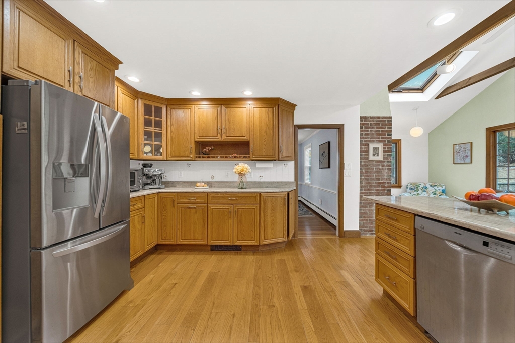 15 Spring Valley Road Belmont, MA 02478 - Photo 6 of 29 a kitchen with stainless steel appliances a refrigerator and a stove top oven