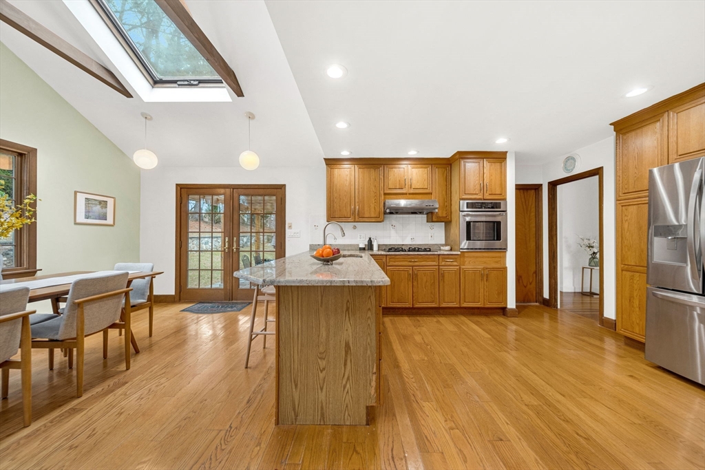 15 Spring Valley Road Belmont, MA 02478 - Photo 9 of 29 a large kitchen with cabinets wooden floor stainless steel appliances and view living room