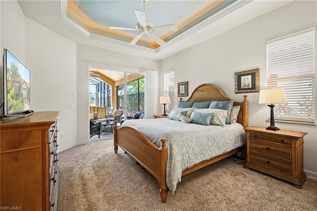 12592 Grandezza Circle Estero, FL 33928 - Photo 19 of 40 a bedroom with a bed and a dresser next to a window