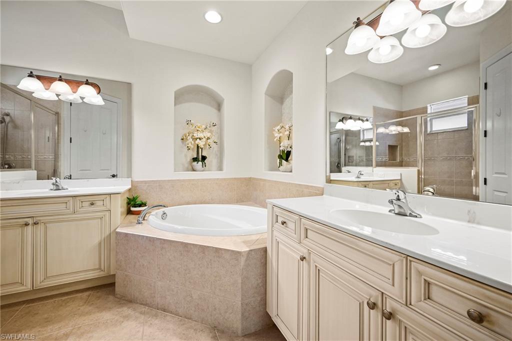 12592 Grandezza Circle Estero, FL 33928 - Photo 20 of 40 a bathroom with a double vanity sink mirror and bathtub
