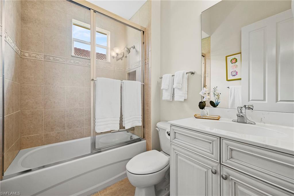 12592 Grandezza Circle Estero, FL 33928 - Photo 22 of 40 a bathroom with a granite countertop sink toilet and shower