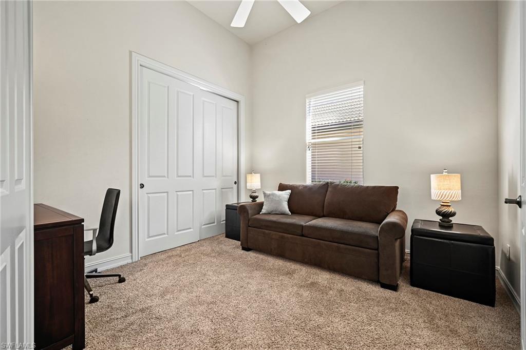 12592 Grandezza Circle Estero, FL 33928 - Photo 23 of 40 a living room with furniture a flat screen tv and a window