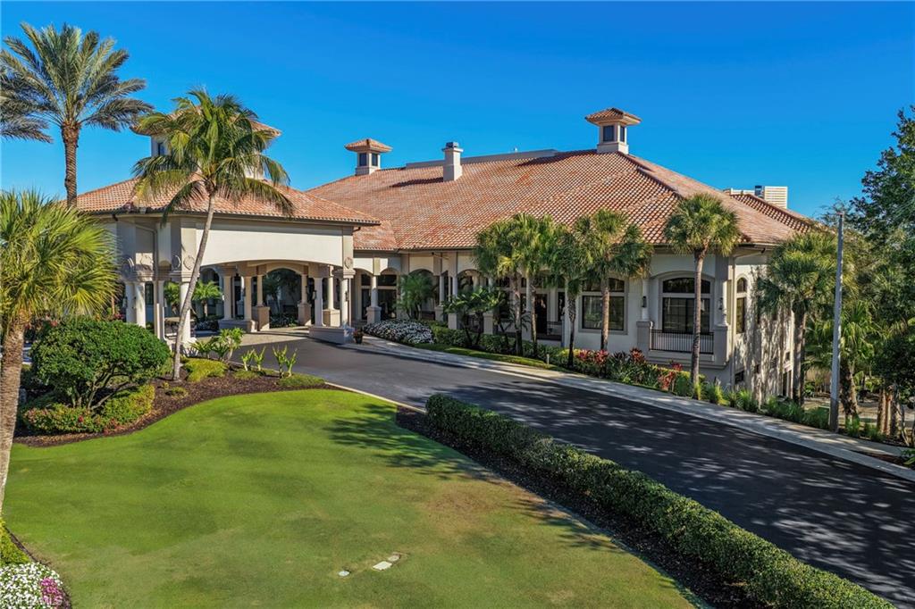 12592 Grandezza Circle Estero, FL 33928 - Photo 31 of 40 a view of a white house with a yard table and chairs