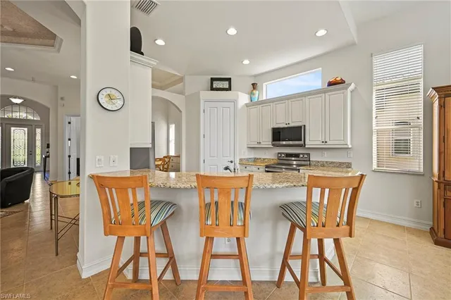 a view of a dining room with furniture and a window