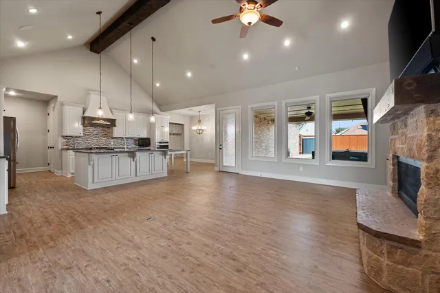 an open kitchen with kitchen island and stainless steel appliances