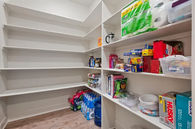 a utility room with fridge and a bed