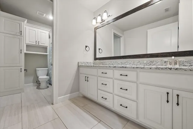 a bathroom with a toilet and a shower curtain