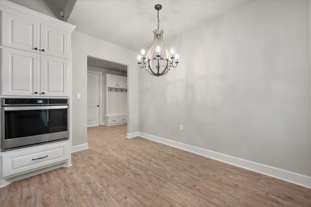 a view of a kitchen with stove and cabinets