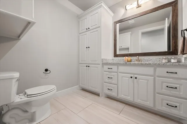 an empty room with a window and a ceiling fan