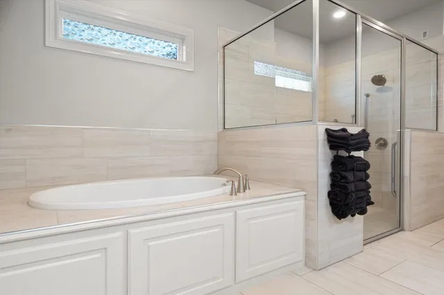 a view of walk in closet with clothes