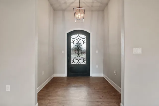 an view of an entryway with a chandelier