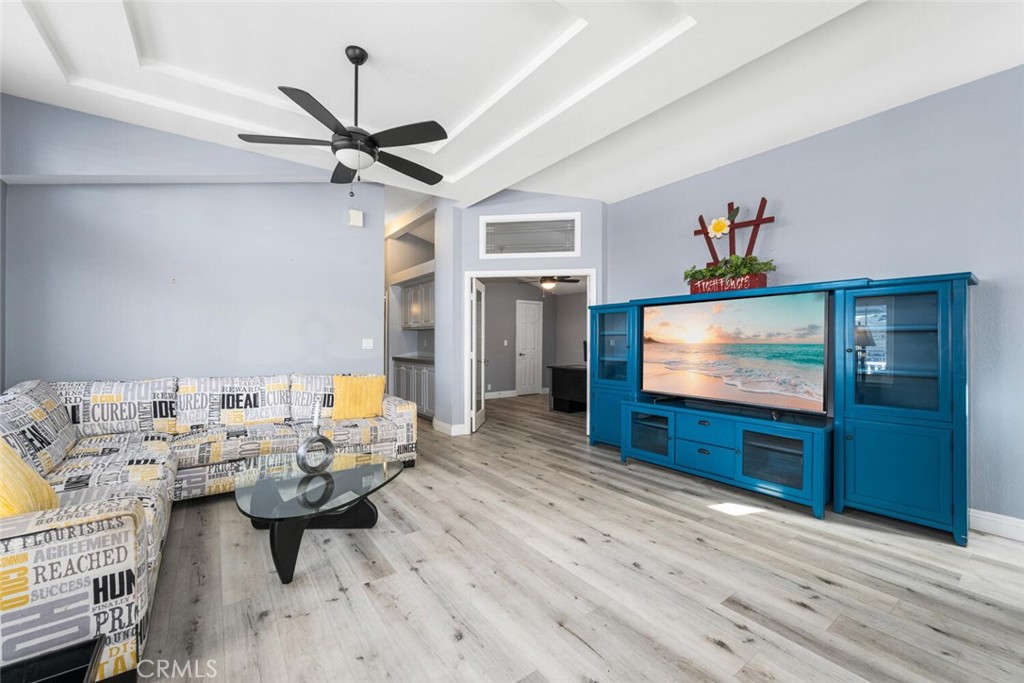 16222 Monterey Lane, Unit 371 Huntington Beach, CA 92649 - Photo 24 of 70 a living room with furniture and a flat screen tv