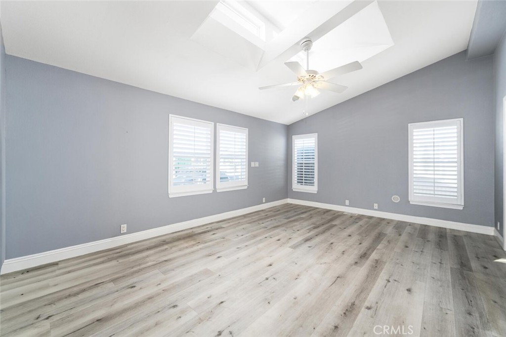 16222 Monterey Lane, Unit 371 Huntington Beach, CA 92649 - Photo 26 of 70 an empty room with wooden floor and windows