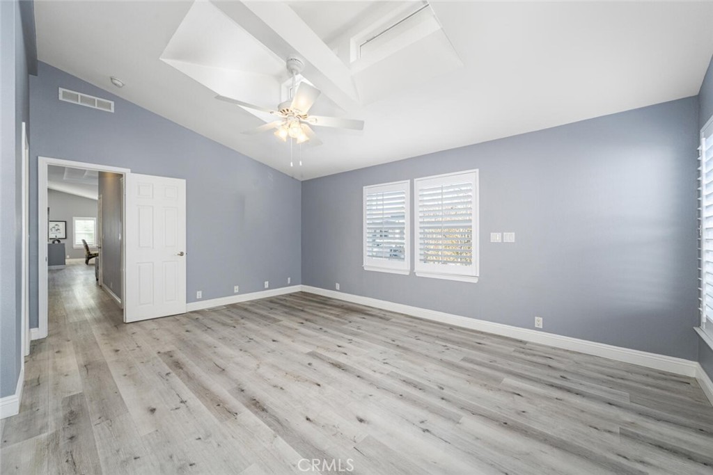 16222 Monterey Lane, Unit 371 Huntington Beach, CA 92649 - Photo 29 of 70 a view of an empty room with wooden floor and a window