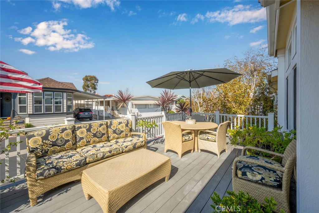 16222 Monterey Lane, Unit 371 Huntington Beach, CA 92649 - Photo 3 of 70 a view of a rooftop deck with couch and chairs