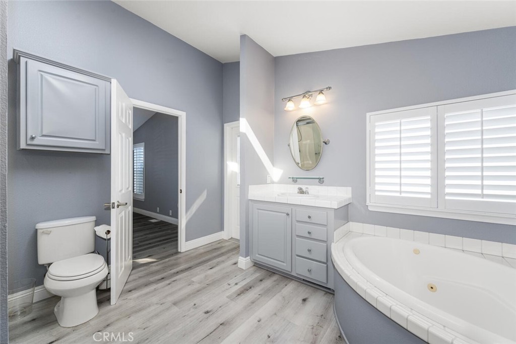 16222 Monterey Lane, Unit 371 Huntington Beach, CA 92649 - Photo 31 of 70 a bathroom with a toilet sink and mirror