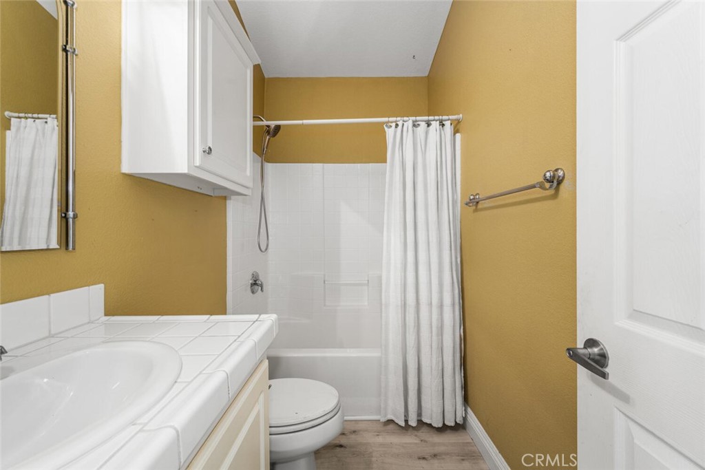 16222 Monterey Lane, Unit 371 Huntington Beach, CA 92649 - Photo 37 of 70 a bathroom with a toilet a sink and bathtub
