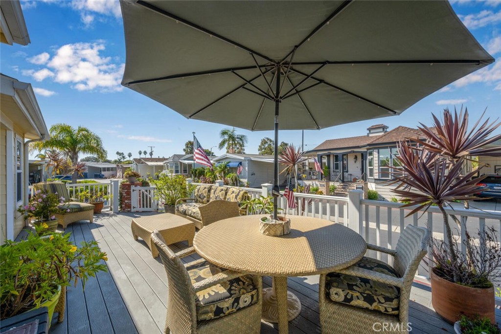 16222 Monterey Lane, Unit 371 Huntington Beach, CA 92649 - Photo 4 of 70 a view of a dining room with furniture wooden floor and chandelier