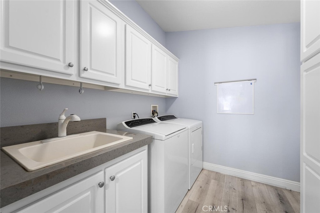 16222 Monterey Lane, Unit 371 Huntington Beach, CA 92649 - Photo 43 of 70 Huge laundry room sporting sink and lots of overhead storage.