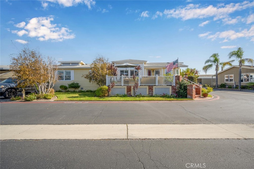 16222 Monterey Lane, Unit 371 Huntington Beach, CA 92649 - Photo 67 of 70 a front view of a house with a yard