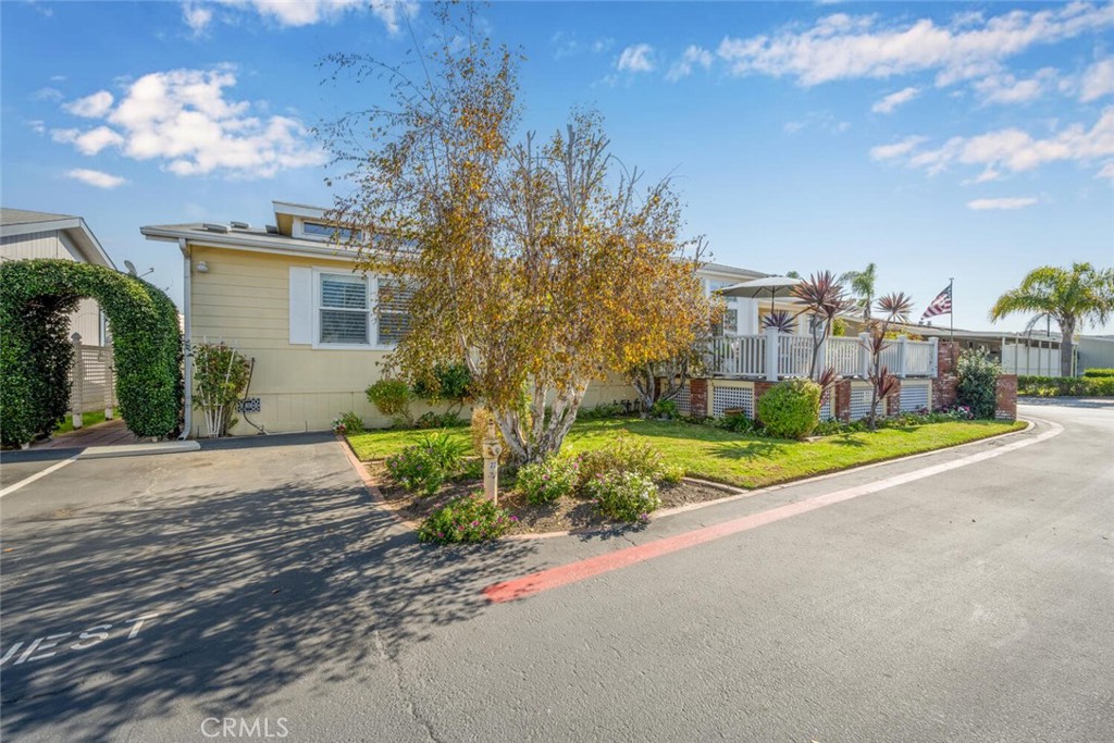 16222 Monterey Lane, Unit 371 Huntington Beach, CA 92649 - Photo 69 of 70 a view of a house with a yard and pathway