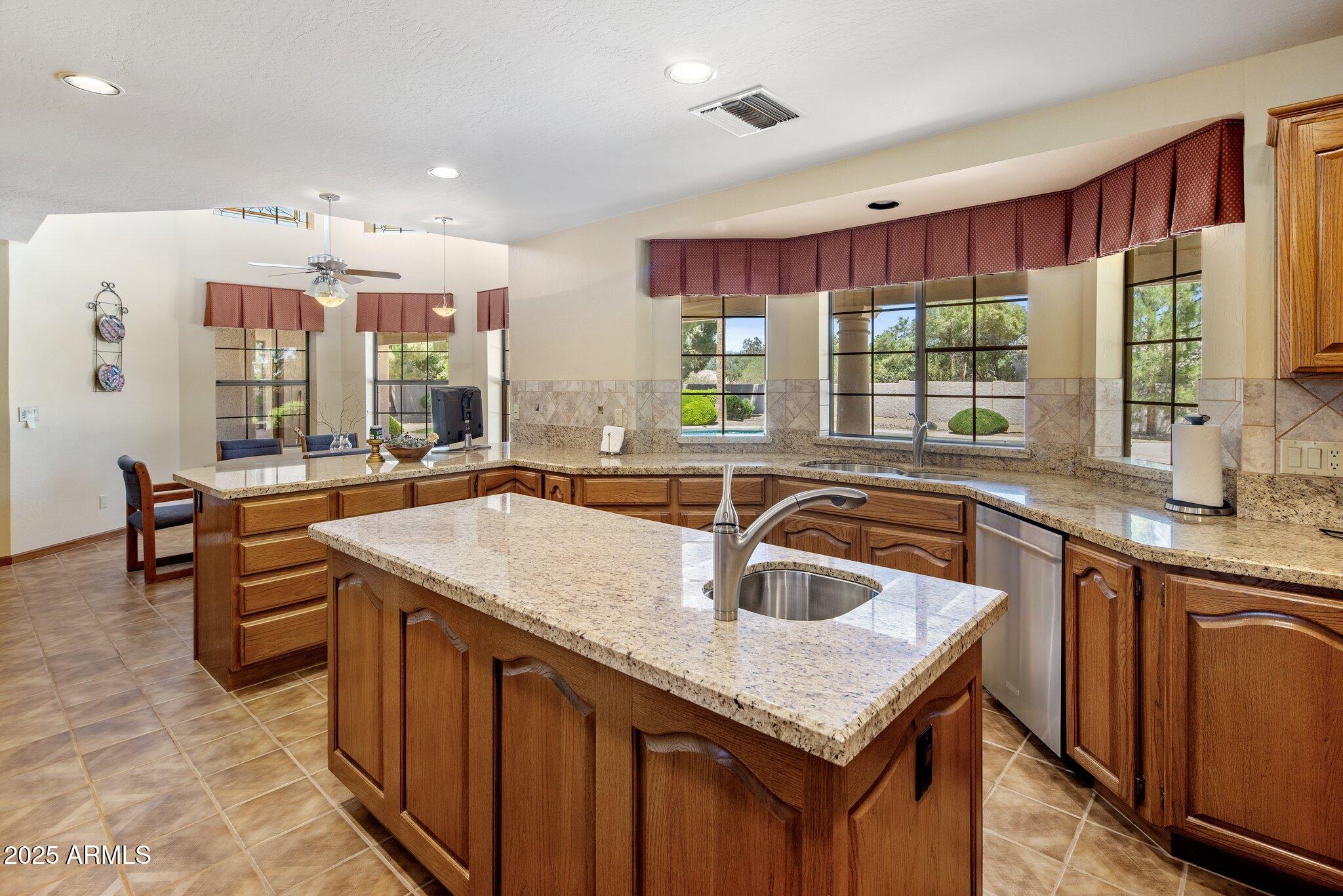 8815 North Invergordon Road Paradise Valley, AZ 85253 - Photo 11 of 22 a kitchen with granite countertop a sink and a counter top space