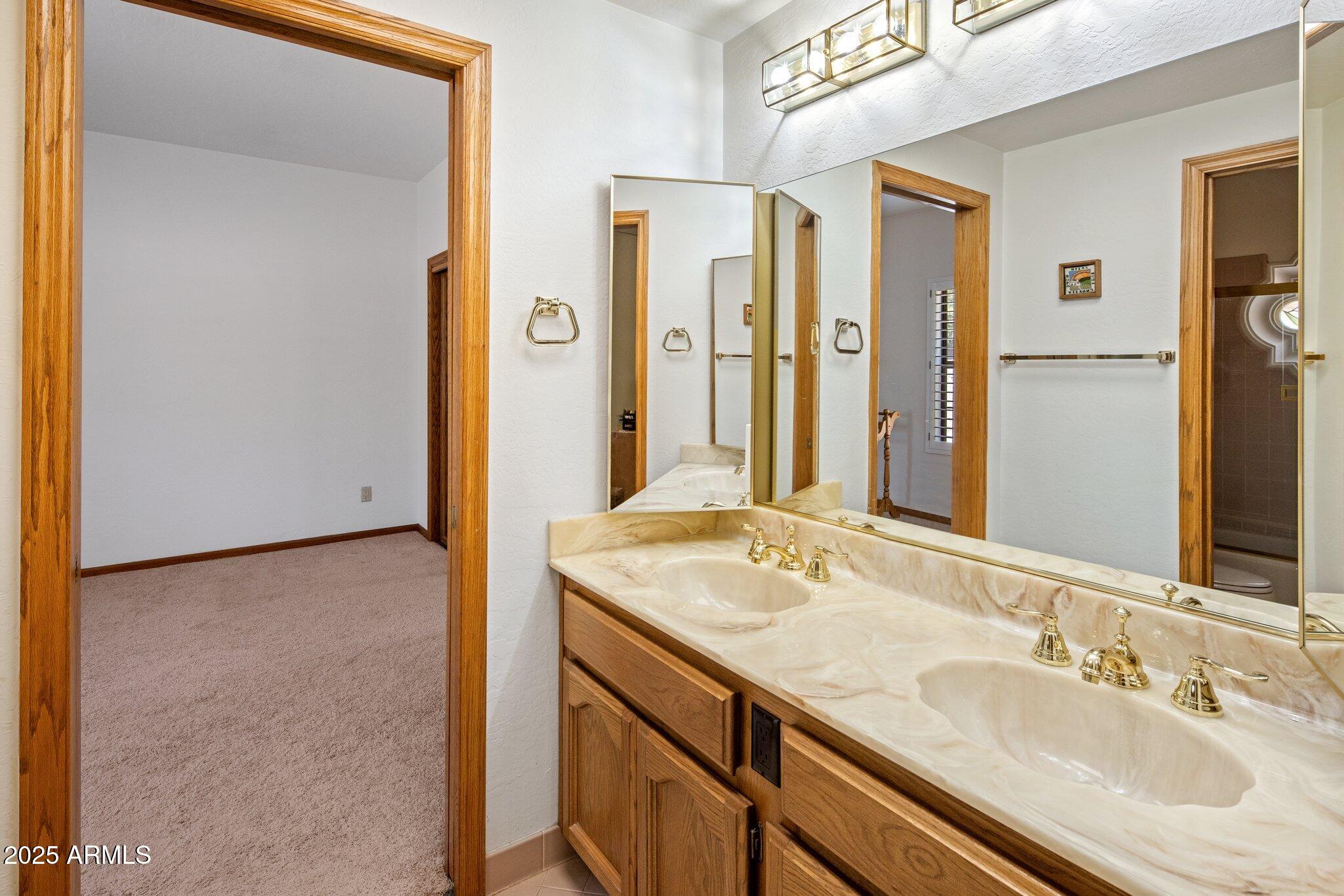 8815 North Invergordon Road Paradise Valley, AZ 85253 - Photo 16 of 22 a bathroom with a granite countertop sink and a mirror