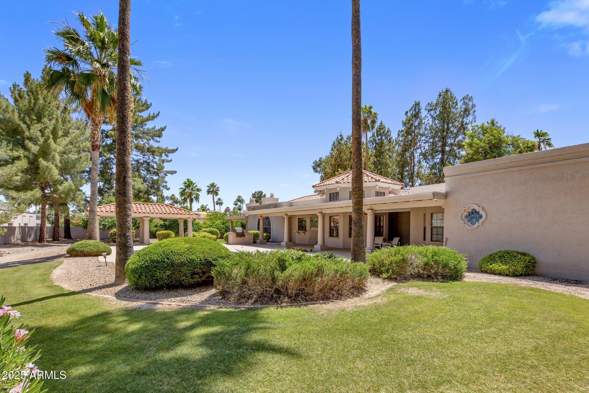 8815 North Invergordon Road Paradise Valley, AZ 85253 - Photo 20 of 22 a front view of a house with garden and trees