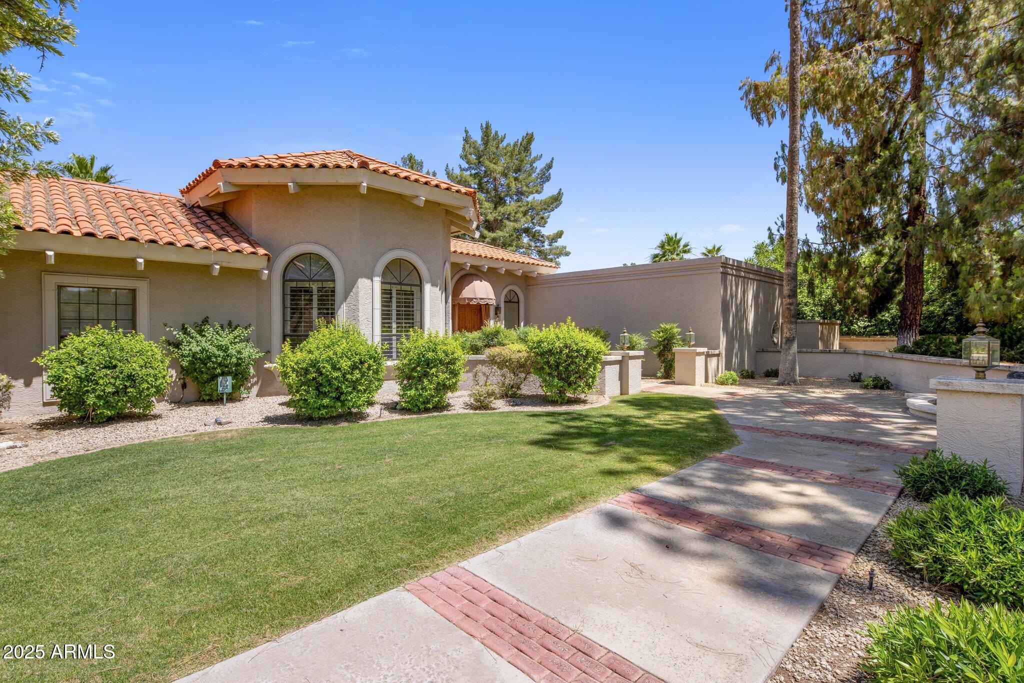 8815 North Invergordon Road Paradise Valley, AZ 85253 - Photo 2 of 22 a front view of a house with a yard