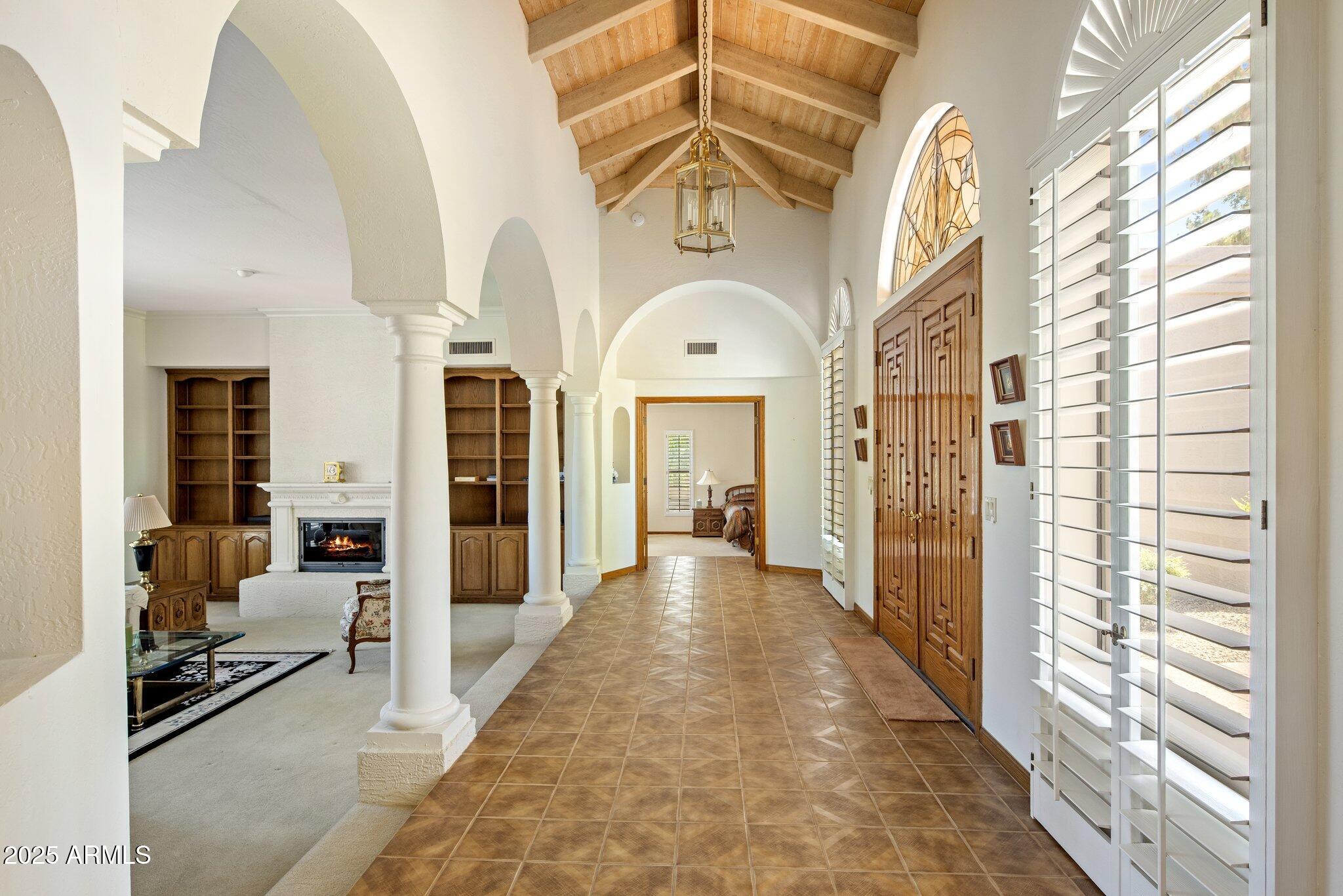 8815 North Invergordon Road Paradise Valley, AZ 85253 - Photo 5 of 22 a view of a hallway with living room and chandelier