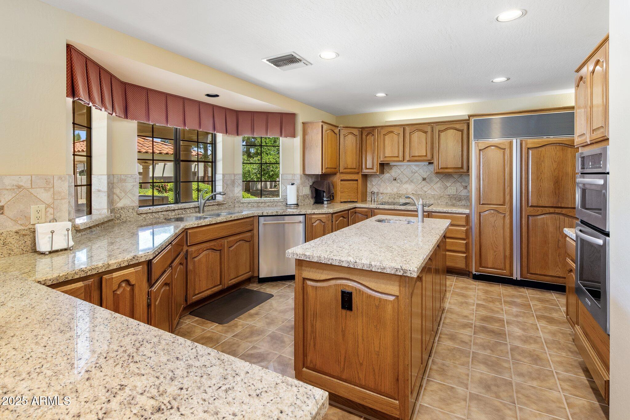 8815 North Invergordon Road Paradise Valley, AZ 85253 - Photo 9 of 22 a kitchen with a stove a refrigerator and a sink
