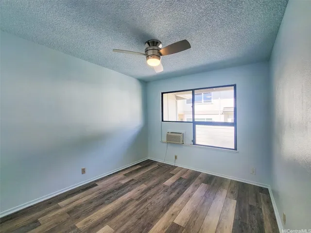 a spacious bedroom with a large bed couch and a large window
