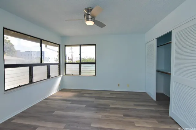 a spacious bathroom with a double vanity sink a toilet and a mirror