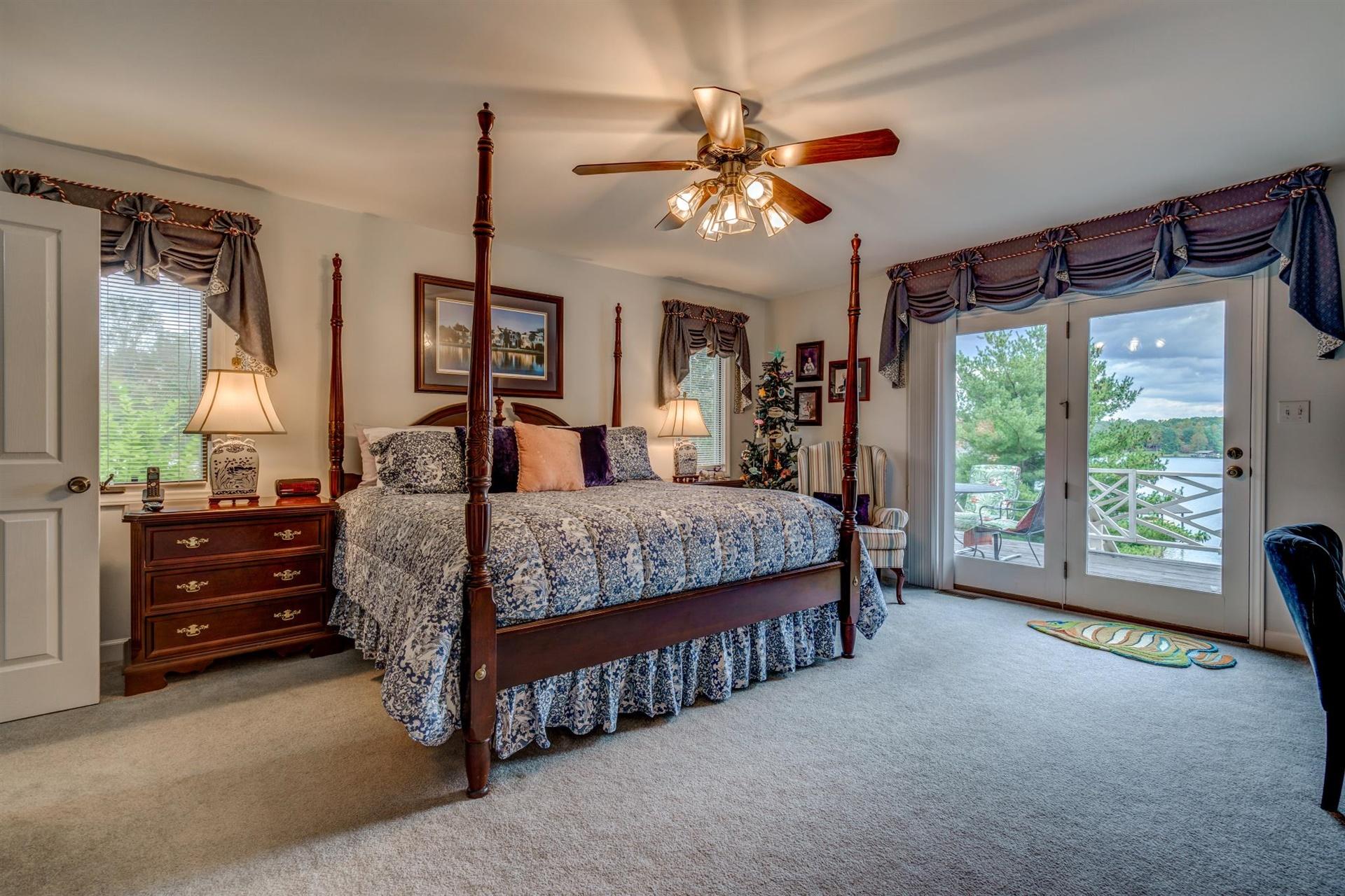 469 Cedar Ridge Road Union Hall, VA 24176 - Photo 14 of 54 a bedroom with a large bed and a chandelier fan