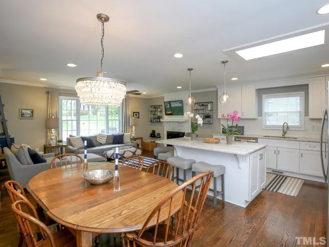 a large kitchen with a table and chairs