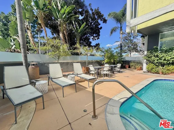 a view of a patio with swimming pool