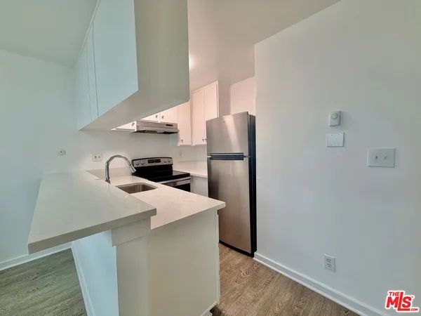 a kitchen with stainless steel appliances a refrigerator and a sink