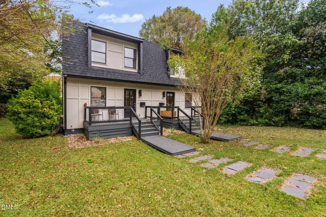 a view of a house with backyard porch and sitting area