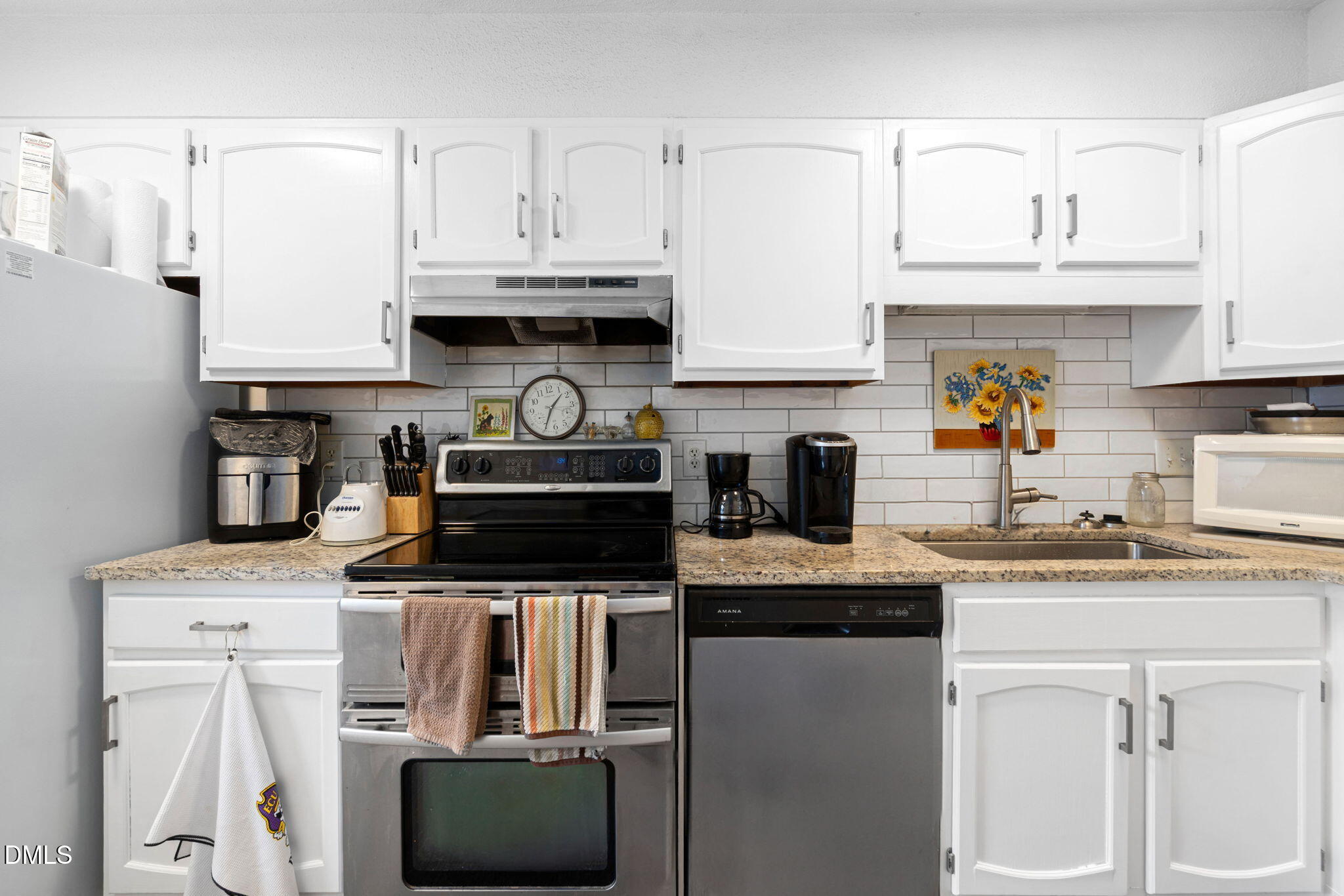 215 1/2 Lafayette Road, Unit A Raleigh, NC 27604 - Photo 17 of 39 a kitchen with stainless steel appliances granite countertop a sink stove and cabinets