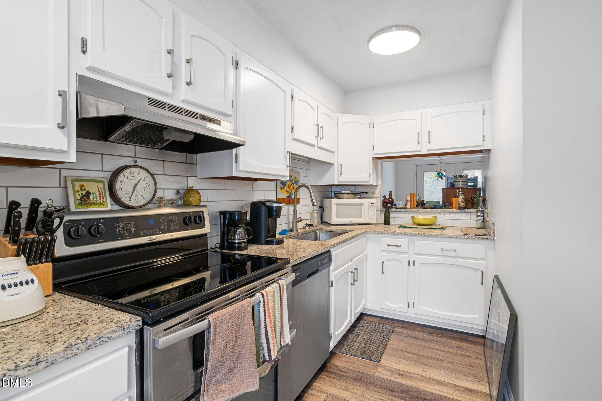 215 1/2 Lafayette Road, Unit A Raleigh, NC 27604 - Photo 19 of 39 a kitchen with stainless steel appliances granite countertop a stove and cabinets