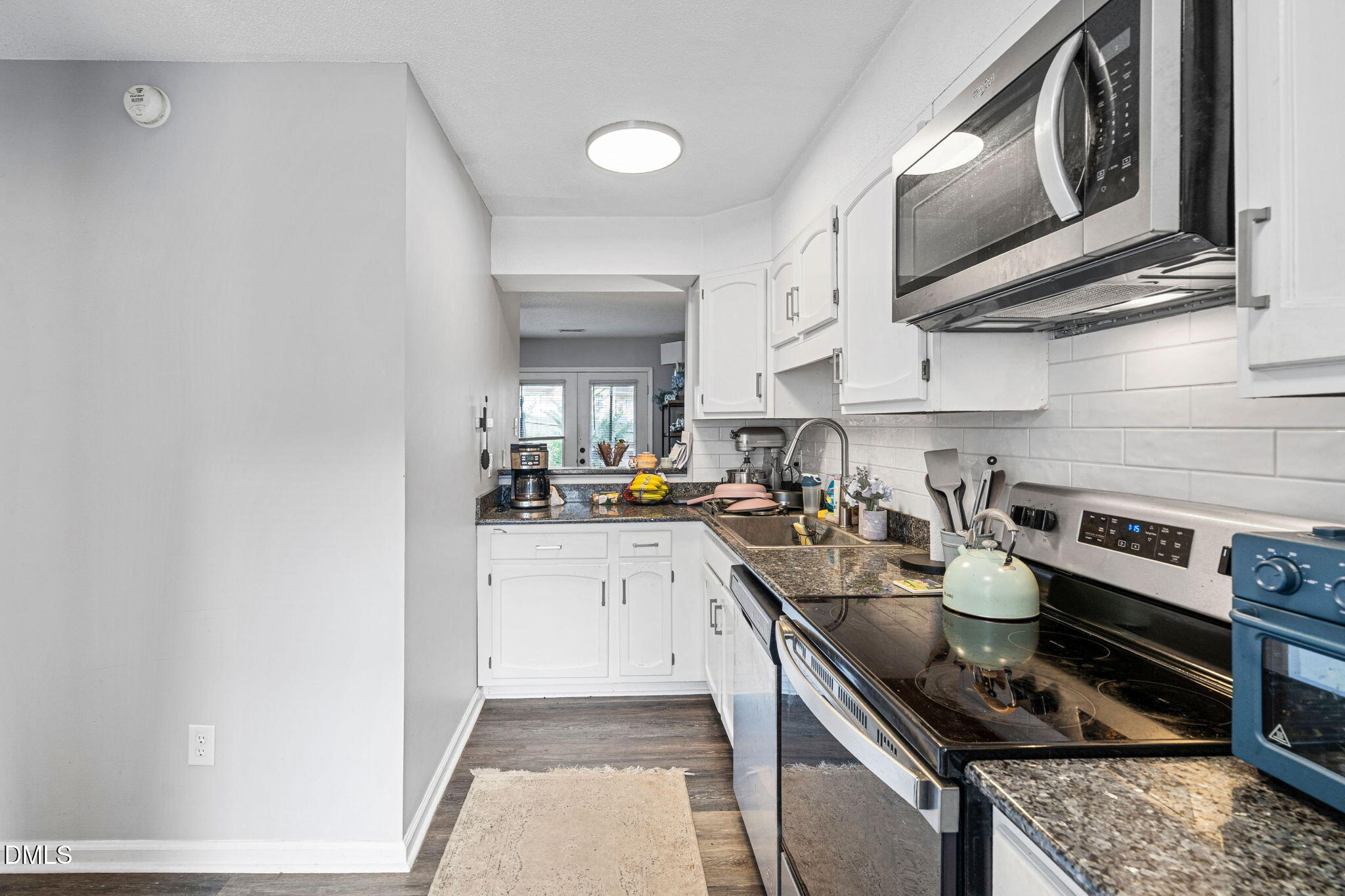 215 1/2 Lafayette Road, Unit A Raleigh, NC 27604 - Photo 20 of 39 a kitchen with stainless steel appliances granite countertop a stove and a sink