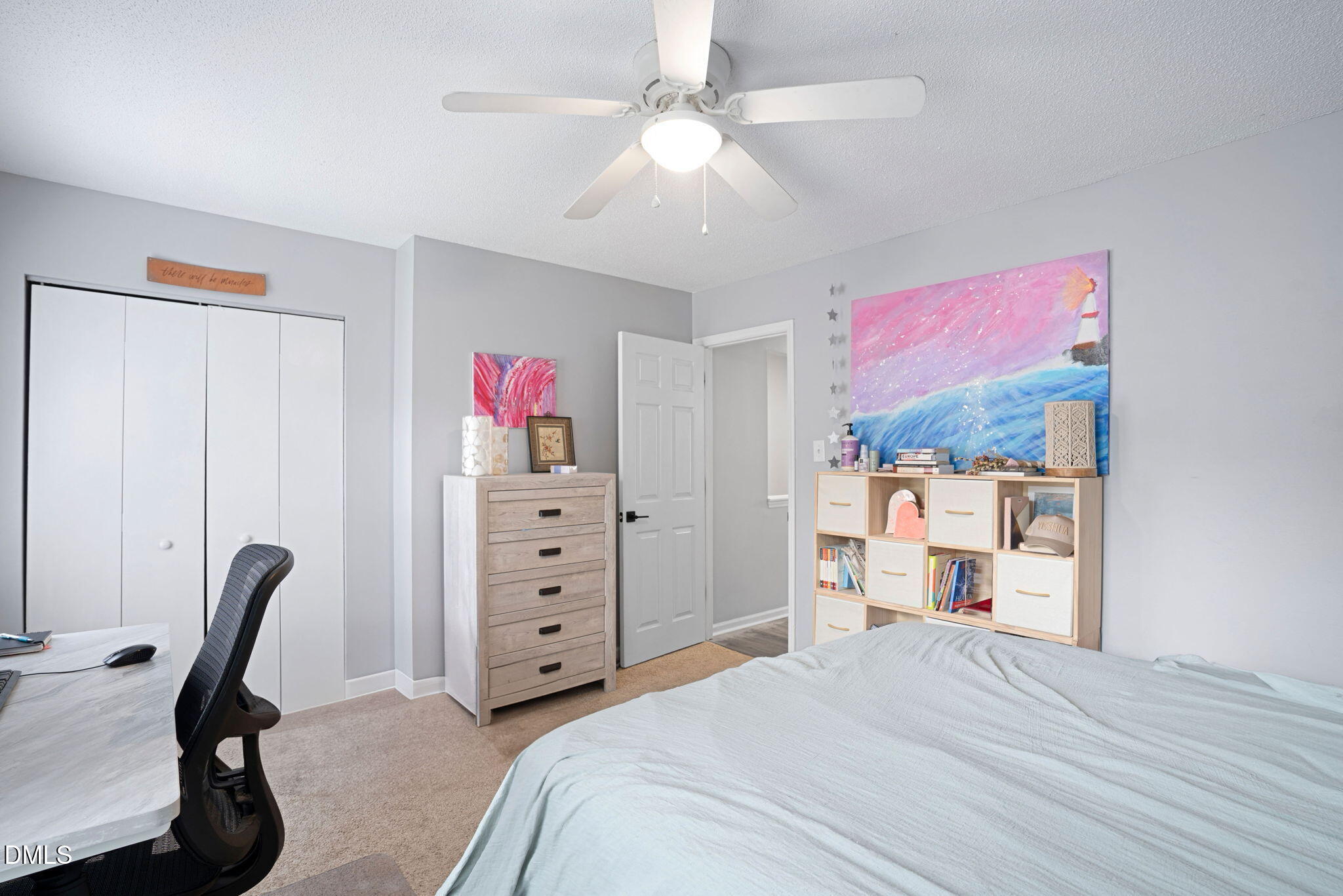 215 1/2 Lafayette Road, Unit A Raleigh, NC 27604 - Photo 25 of 39 a bedroom with a bed a desk and chair with a bookshelf