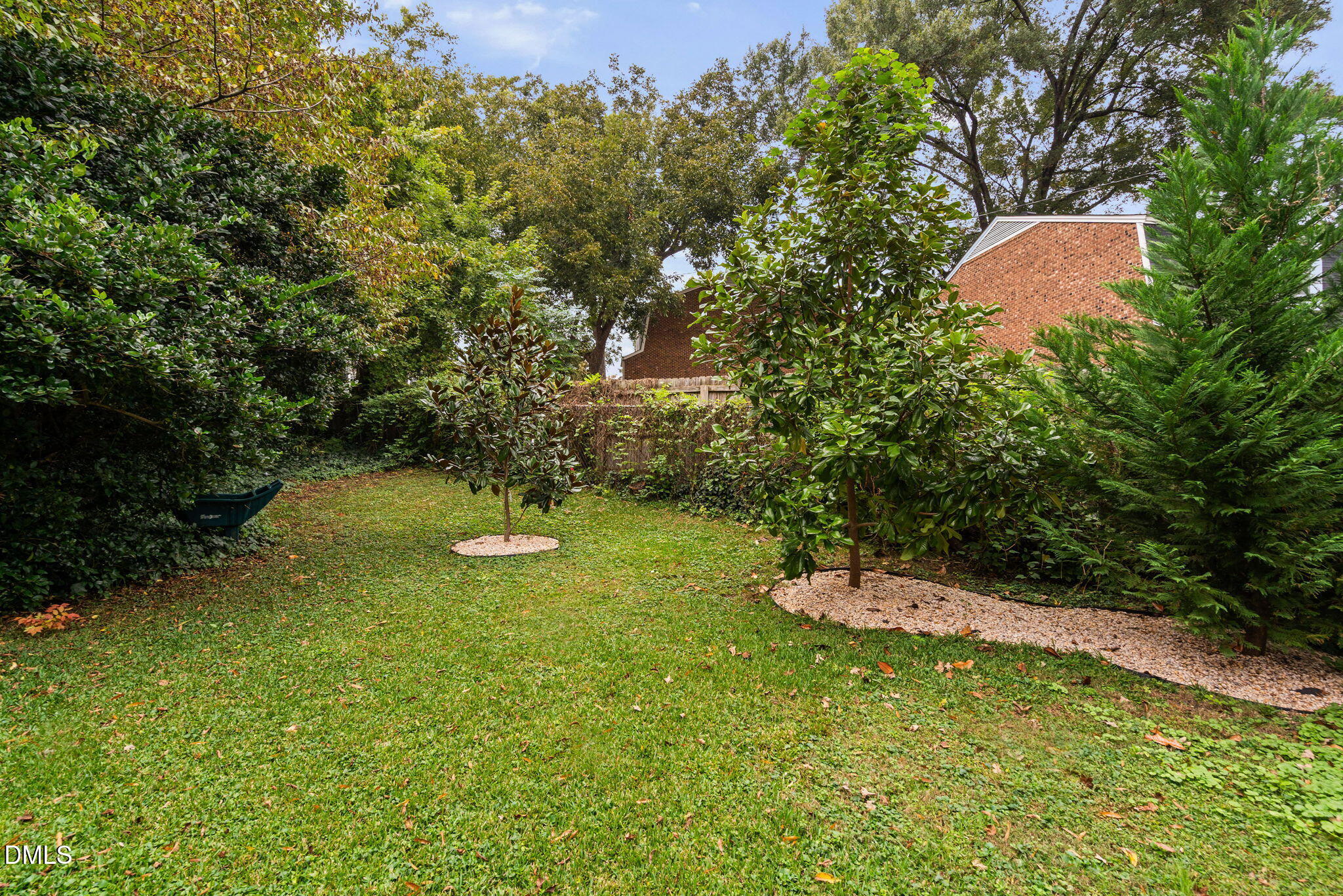 215 1/2 Lafayette Road, Unit A Raleigh, NC 27604 - Photo 38 of 39 a backyard of a house with table and chairs