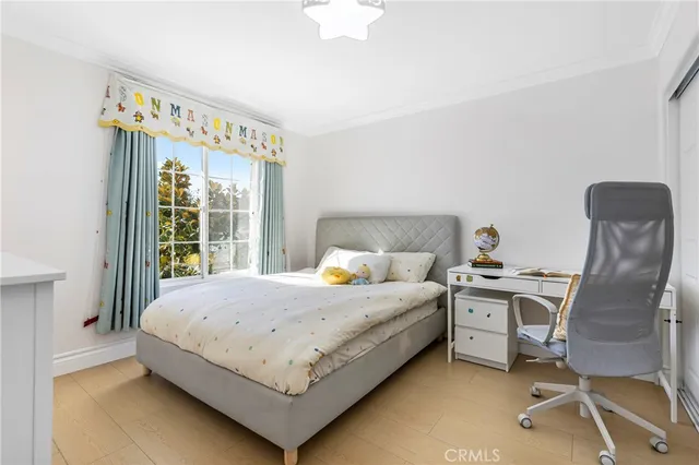 a bedroom with a bed chair and a window