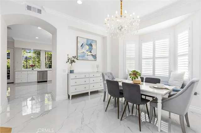 a view of a dining room with furniture and windows