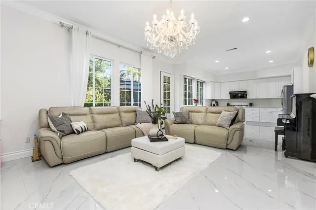 a living room with furniture or chandelier and a dining table