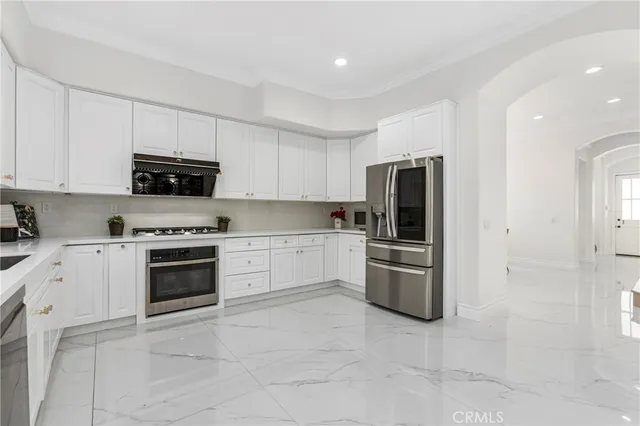 a kitchen with a stove sink and refrigerator
